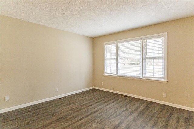 453 Utoy Cir SW, Atlanta, GA 30331 - spare room with a textured ceiling and dark hardwood / wood-style floors
