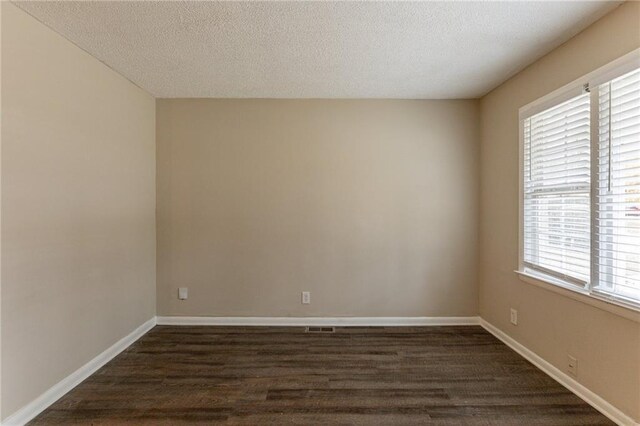 453 Utoy Cir SW, Atlanta, GA 30331 - unfurnished room with a healthy amount of sunlight, dark hardwood / wood-style flooring, and a textured ceiling