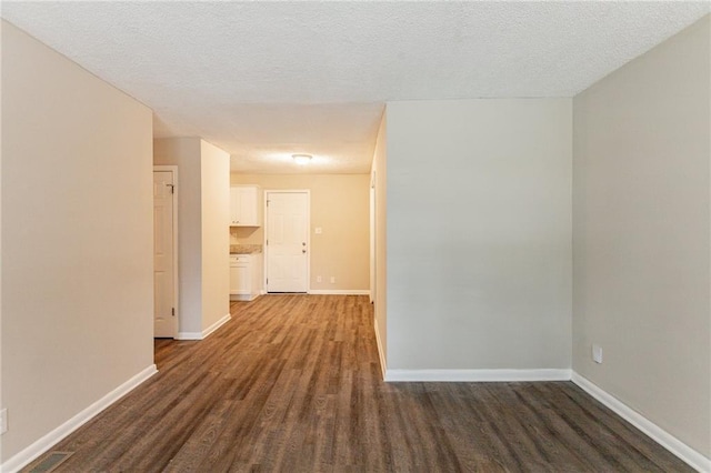 453 Utoy Cir SW, Atlanta, GA 30331 - corridor with a textured ceiling and dark hardwood / wood-style floors