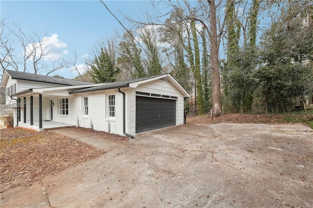 view of home's exterior featuring a porch and a garage