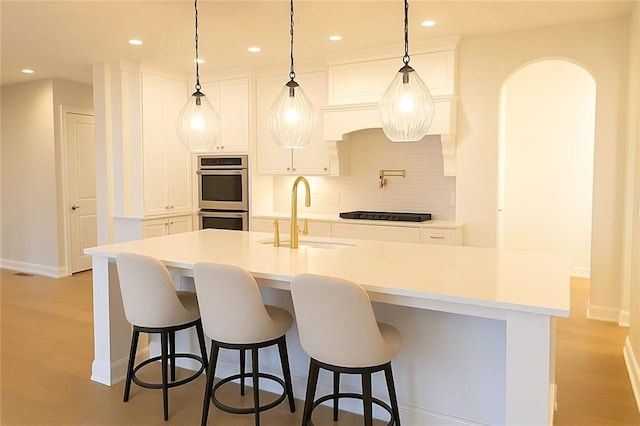 6355 Westfallen Overlook, Cumming, GA 30040 - kitchen featuring decorative backsplash, stainless steel double oven, a sink, and white cabinets