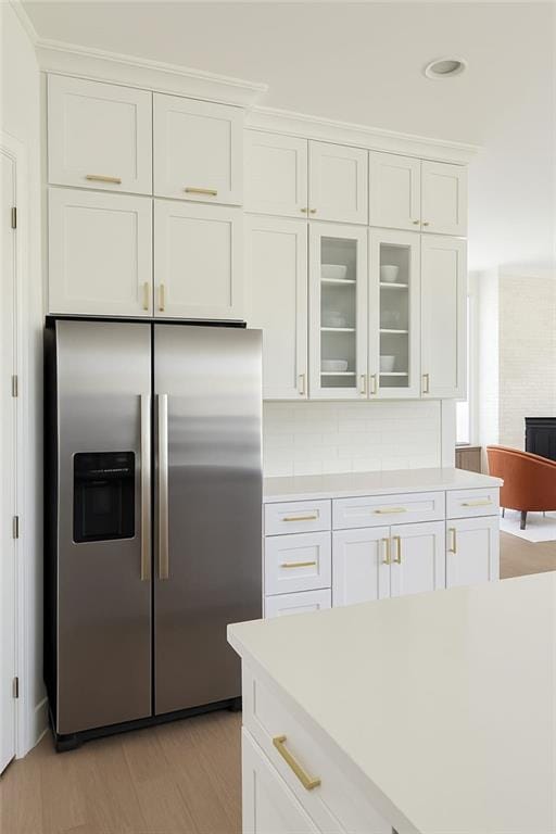 6355 Westfallen Overlook, Cumming, GA 30040 - kitchen featuring glass insert cabinets, stainless steel fridge with ice dispenser, decorative backsplash, light countertops, and white cabinets