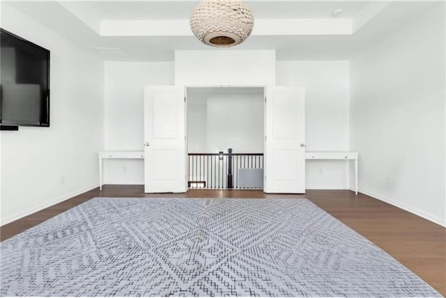 6355 Westfallen Overlook, Cumming, GA 30040 - empty room featuring a raised ceiling, baseboards, and wood finished floors