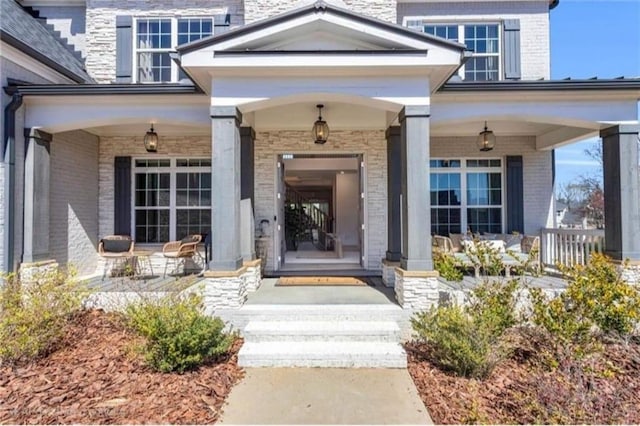 6355 Westfallen Overlook, Cumming, GA 30040 - doorway to property featuring a porch and brick siding