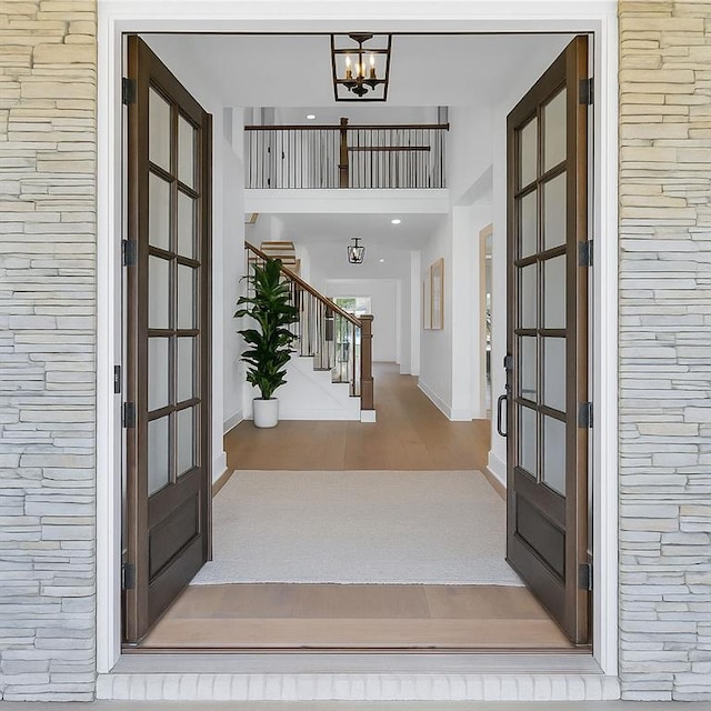 6355 Westfallen Overlook, Cumming, GA 30040 - foyer entrance featuring stairs, french doors, a chandelier, and wood finished floors