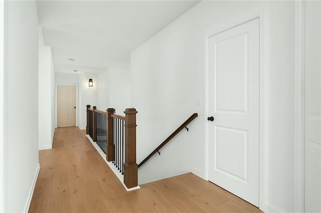 6355 Westfallen Overlook, Cumming, GA 30040 - corridor featuring baseboards, an upstairs landing, and light wood-style floors