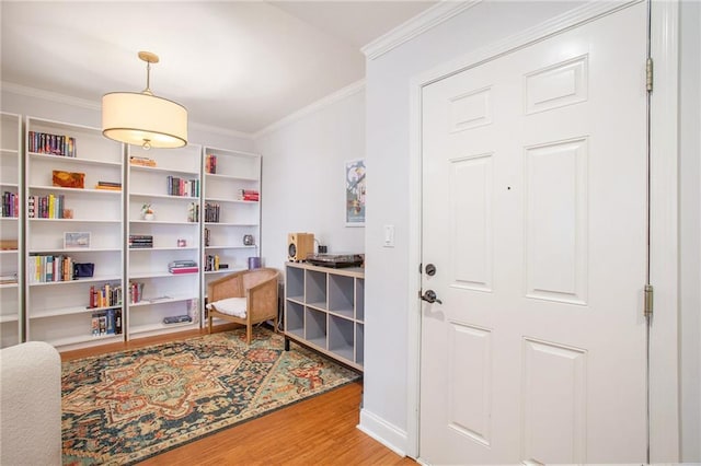 interior space with hardwood / wood-style flooring and ornamental molding