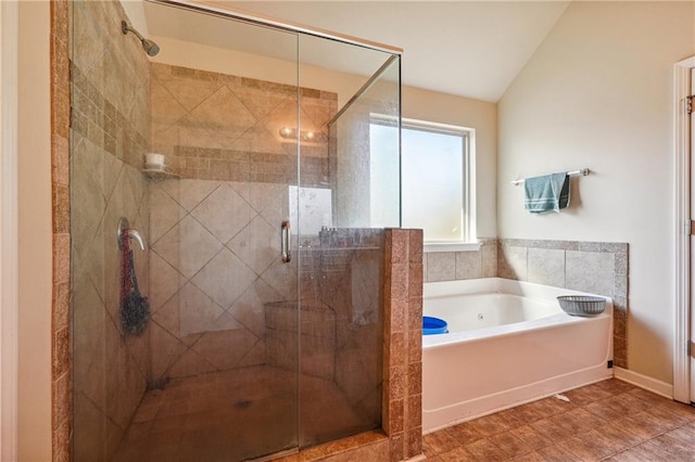 bathroom featuring tile patterned floors, lofted ceiling, and separate shower and tub