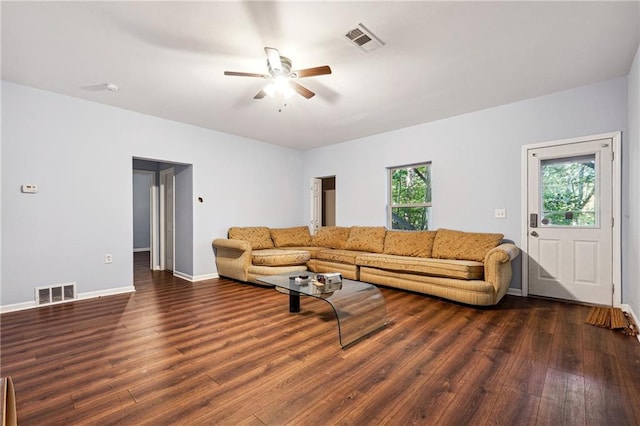 living room featuring ceiling fan, a wealth of natural light, and dark hardwood / wood-style flooring