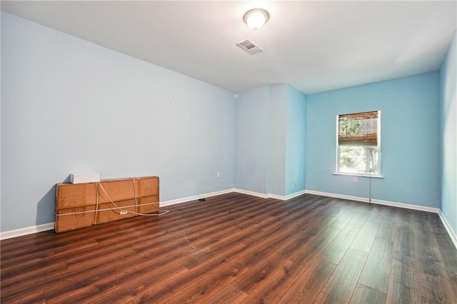 unfurnished room with dark hardwood / wood-style floors