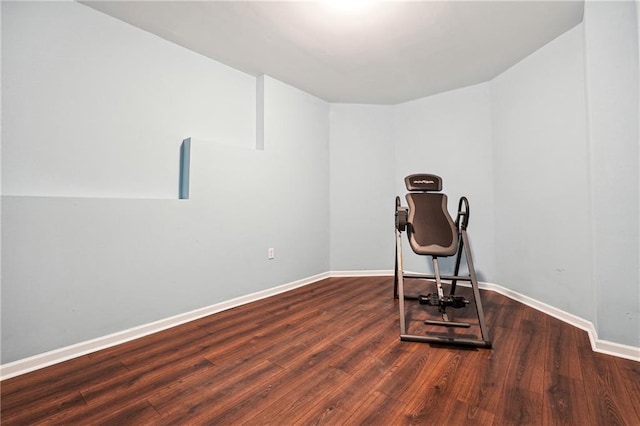 exercise room with dark hardwood / wood-style floors