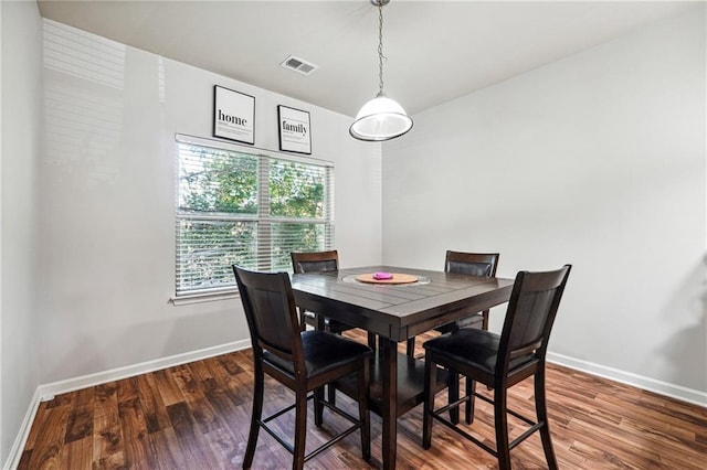 dining room with dark hardwood / wood-style flooring