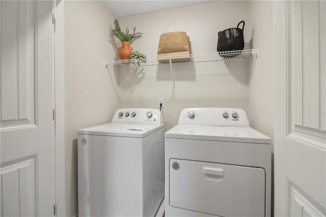 laundry area with washing machine and clothes dryer