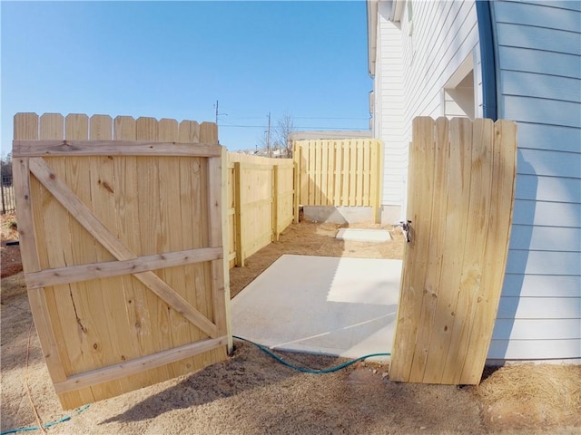 view of gate featuring a patio area