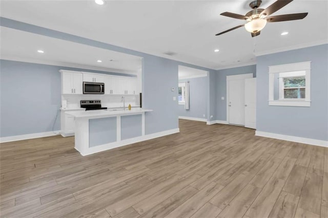 170 Early Sundown Rd, Clarkesville, GA 30523 - kitchen with stainless steel appliances, ornamental molding, open floor plan, ceiling fan, and light wood finished floors