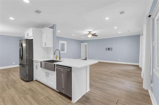 170 Early Sundown Rd, Clarkesville, GA 30523 - kitchen with appliances with stainless steel finishes, crown molding, a ceiling fan, white cabinetry, and light countertops