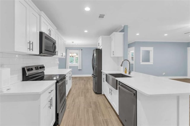 170 Early Sundown Rd, Clarkesville, GA 30523 - kitchen with stainless steel appliances, white cabinets, ornamental molding, light countertops, and light wood finished floors