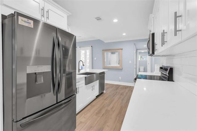 170 Early Sundown Rd, Clarkesville, GA 30523 - kitchen with stainless steel appliances, white cabinetry, light wood-type flooring, light countertops, and recessed lighting