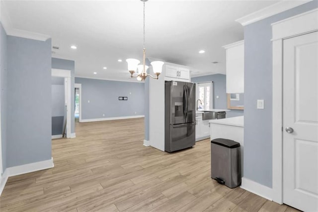 170 Early Sundown Rd, Clarkesville, GA 30523 - kitchen featuring stainless steel fridge, light countertops, a chandelier, white cabinetry, and ornamental molding