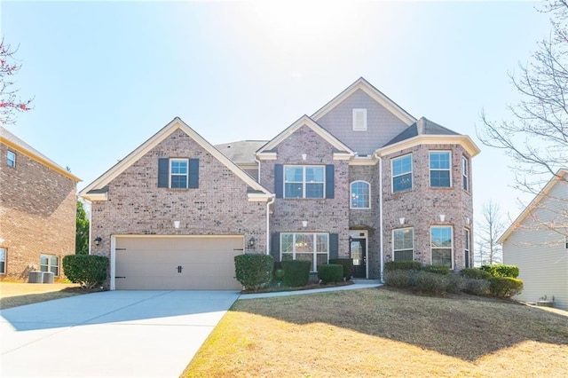 traditional-style home with central AC unit, an attached garage, concrete driveway, and brick siding