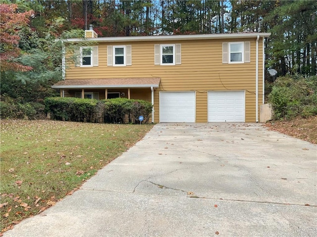 view of front of house with a garage and a front lawn