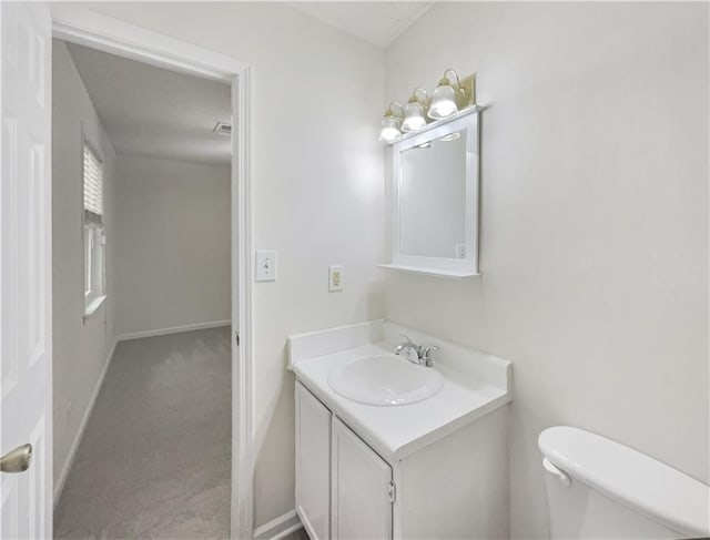 bathroom featuring toilet and vanity