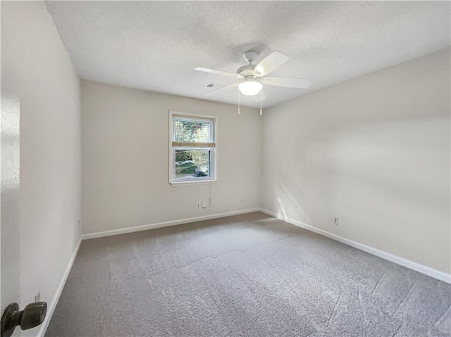 unfurnished room with ceiling fan, carpet flooring, and a textured ceiling