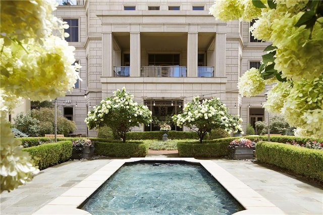 3376 Peachtree Rd NE Unit 35A, Atlanta, GA 30326 - back of house with a balcony, an outdoor pool, and stone siding