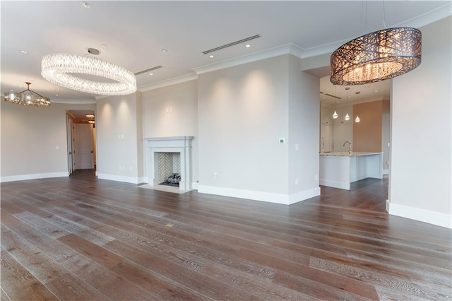 3376 Peachtree Rd NE Unit 35A, Atlanta, GA 30326 - unfurnished living room featuring a chandelier, crown molding, a fireplace with flush hearth, dark wood-type flooring, and baseboards