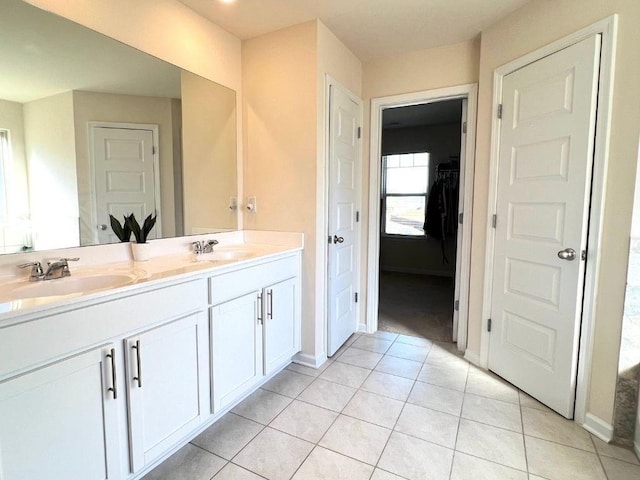 799 Blue Juniper Cir, Loganville, GA 30052 - full bathroom with double vanity, a closet, tile patterned floors, and baseboards