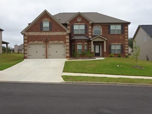 view of front of property with brick siding, a front lawn, a garage, and concrete driveway