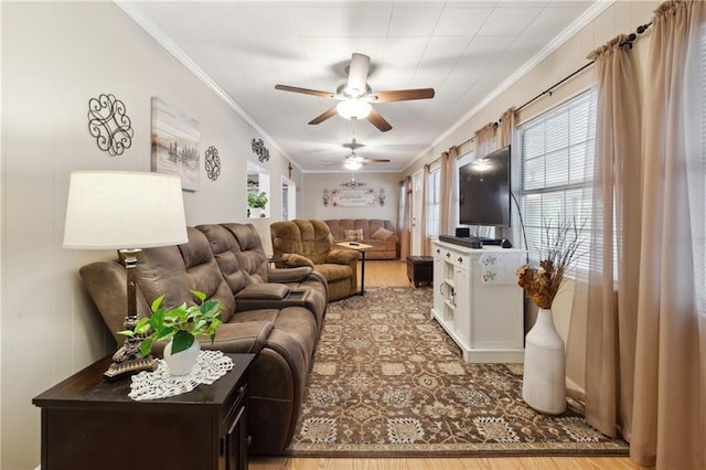 living area with wood finished floors, crown molding, and ceiling fan