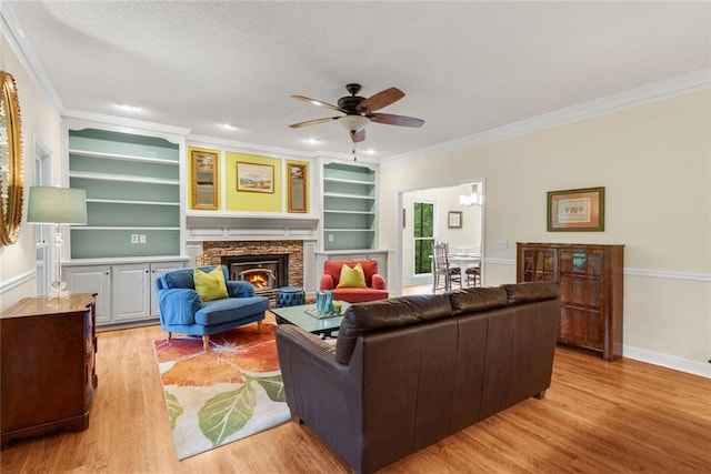 130 Wayne Wheeler Way, Woodstock, GA 30188 - living room with crown molding, ceiling fan, a stone fireplace, light wood-style floors, and built in features