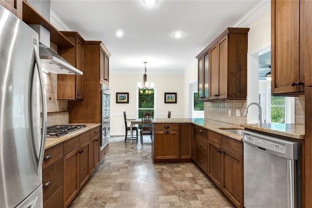 130 Wayne Wheeler Way, Woodstock, GA 30188 - kitchen with stainless steel appliances, backsplash, a chandelier, a peninsula, and ornamental molding