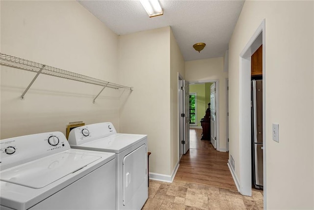 130 Wayne Wheeler Way, Woodstock, GA 30188 - washroom featuring washer and dryer and a textured ceiling