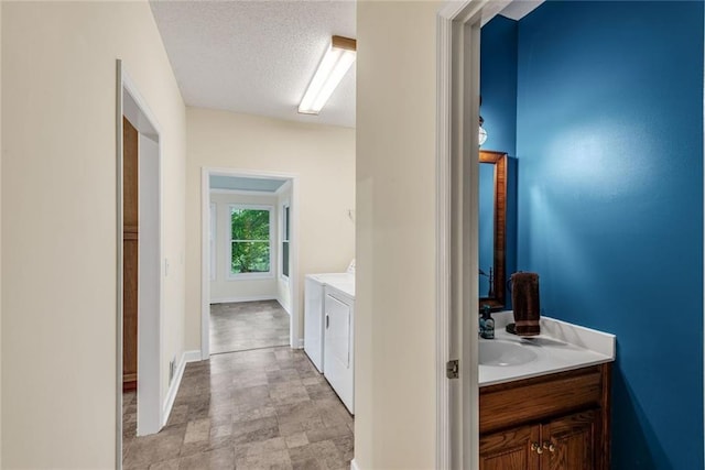 130 Wayne Wheeler Way, Woodstock, GA 30188 - bathroom featuring independent washer and dryer, vanity, and a textured ceiling
