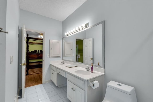 130 Wayne Wheeler Way, Woodstock, GA 30188 - bathroom featuring double vanity, tile patterned flooring, and a textured ceiling
