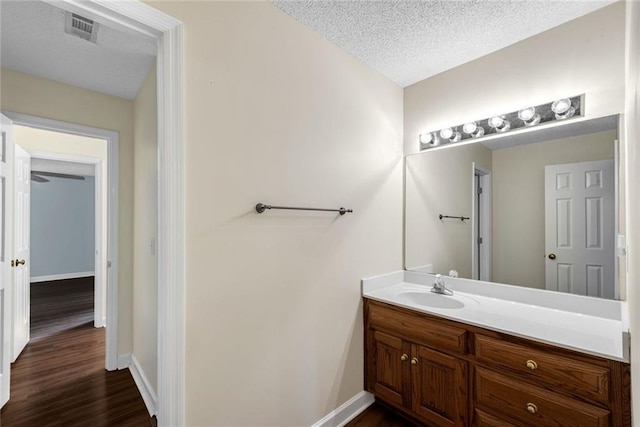 130 Wayne Wheeler Way, Woodstock, GA 30188 - bathroom featuring vanity, wood finished floors, and a textured ceiling
