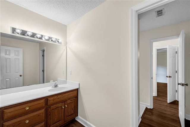 130 Wayne Wheeler Way, Woodstock, GA 30188 - bathroom with a textured ceiling, vanity, and wood finished floors