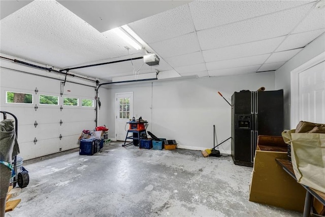 130 Wayne Wheeler Way, Woodstock, GA 30188 - garage with a garage door opener and black fridge