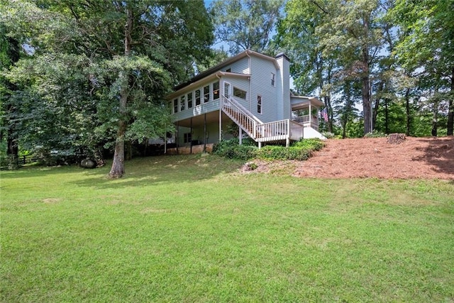 130 Wayne Wheeler Way, Woodstock, GA 30188 - back of property featuring a lawn, a chimney, stairs, and a carport