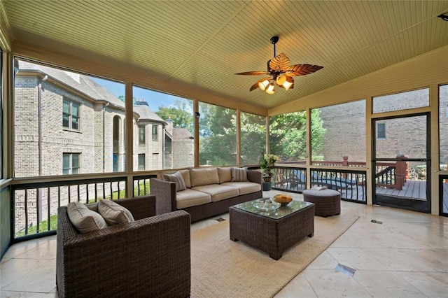 sunroom featuring lofted ceiling, wood ceiling, and a ceiling fan