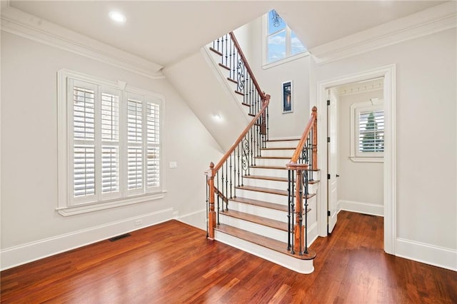 stairs featuring recessed lighting, visible vents, ornamental molding, wood finished floors, and baseboards