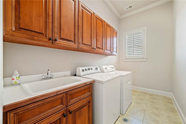 clothes washing area with crown molding, cabinet space, visible vents, a sink, and independent washer and dryer