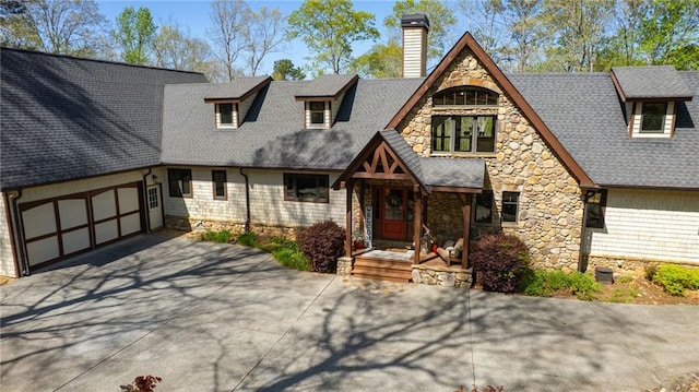 8850 Matt Hwy, Ball Ground, GA 30107 - view of front of home with stone siding, a chimney, concrete driveway, a shingled roof, and an attached garage