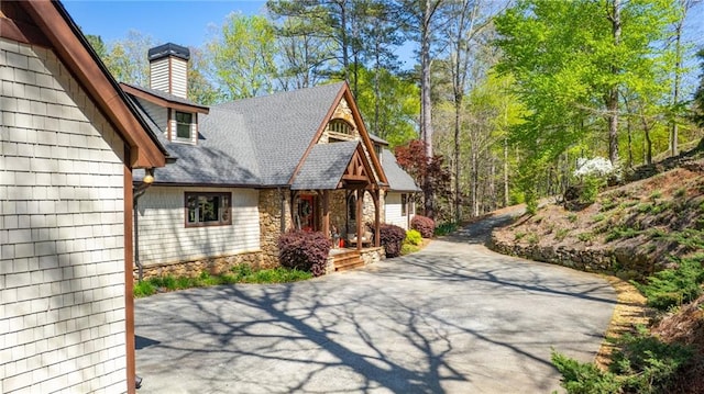 8850 Matt Hwy, Ball Ground, GA 30107 - view of side of property featuring a chimney, stone siding, and roof with shingles