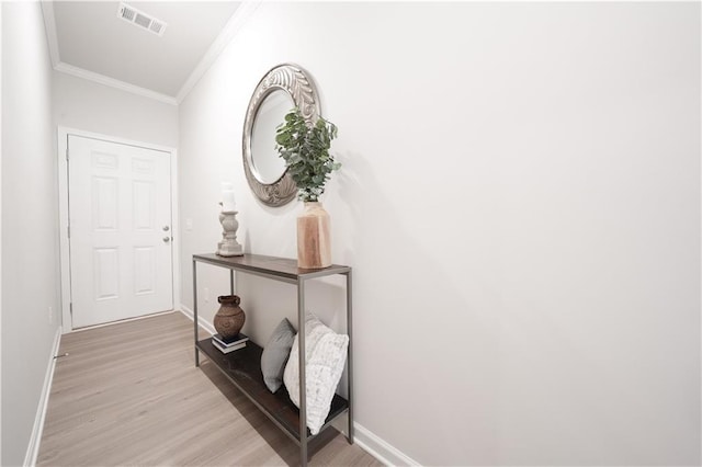 interior space featuring light hardwood / wood-style floors and ornamental molding