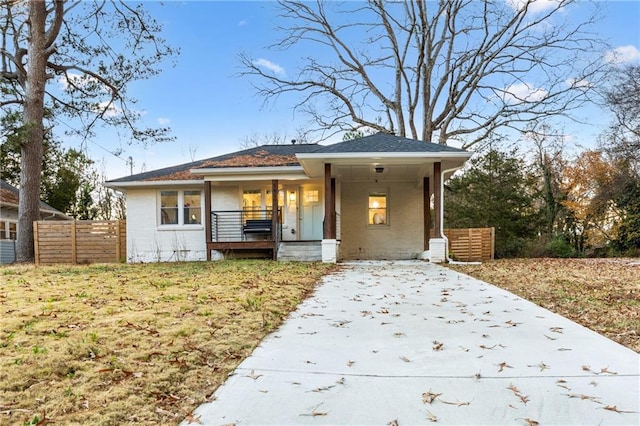 view of front of property with a porch and a front yard