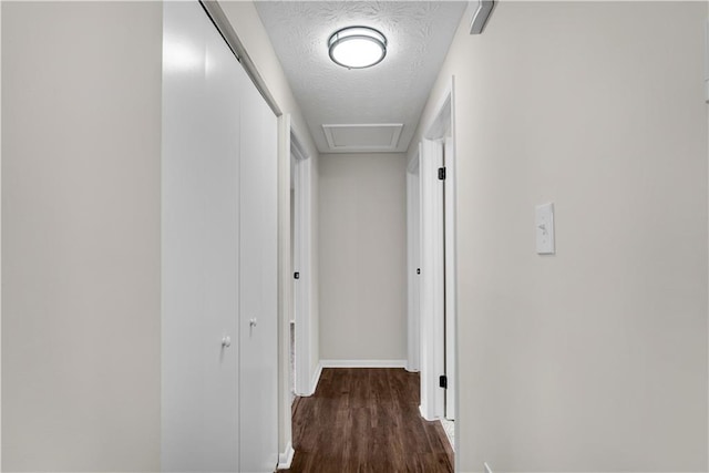 3414 Dearwood Dr SW, Lilburn, GA 30047 - corridor featuring a textured ceiling, wood finished floors, baseboards, and attic access