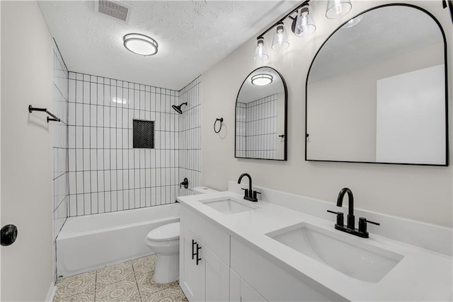 3414 Dearwood Dr SW, Lilburn, GA 30047 - bathroom with toilet, shower / bath combination, double vanity, a textured ceiling, and tile patterned flooring